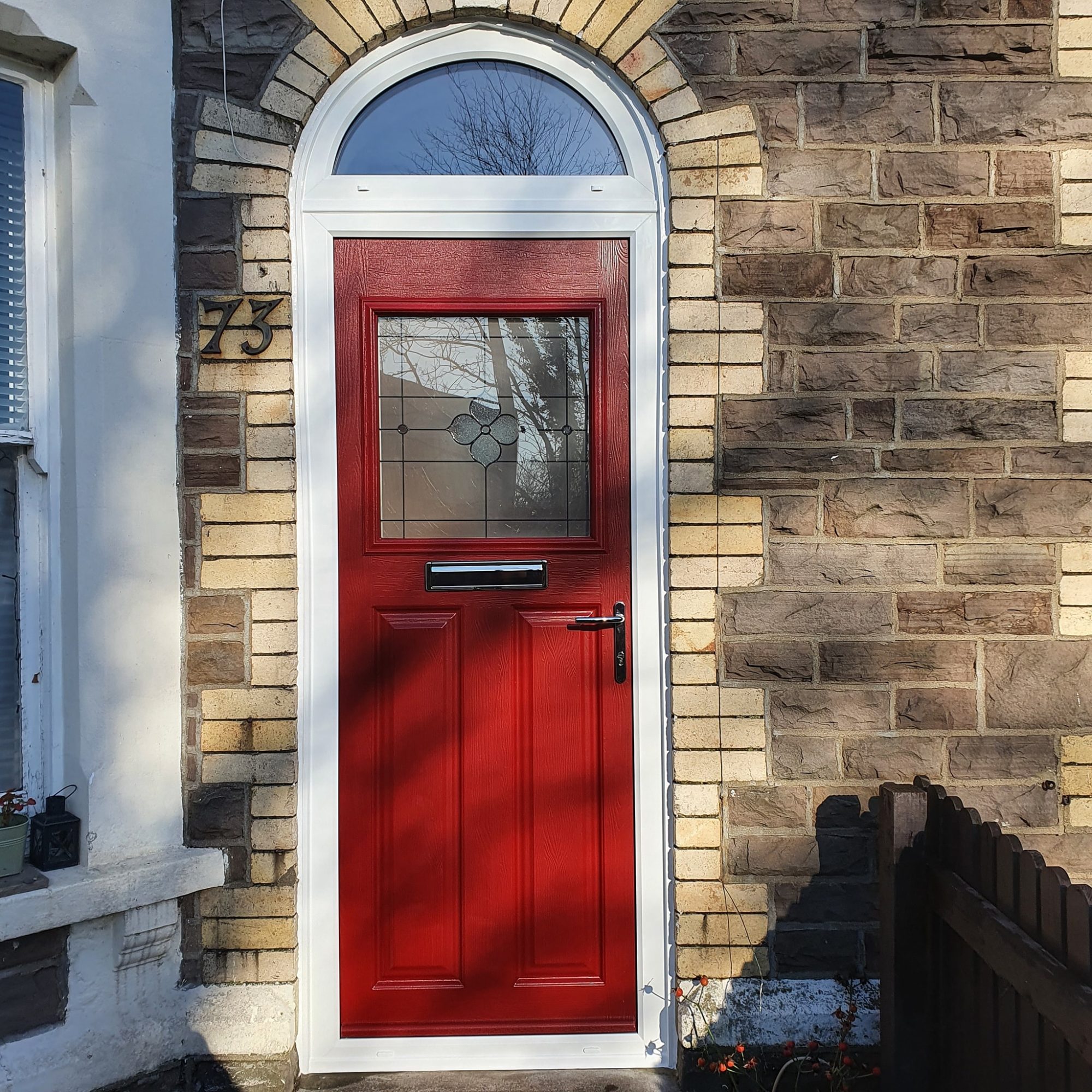 Red UPVC door on front of house